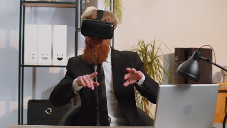 Young business man in vr goggles watch virtual reality video working on simulation game at office