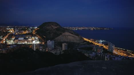 Full-view-of-Alicante's-at-night-seen-from-the-top-of-the-Castle-Santa-Barbara,-spain