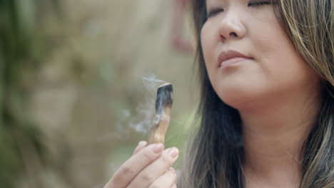 Close-up-shot-of-Japanese-woman-inhaling-scent-of-fragrance