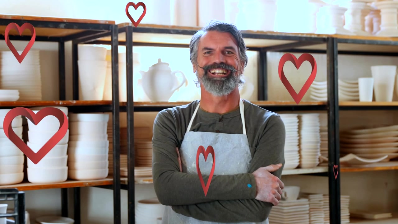 Animazione di icone a forma di cuore su un operaio maschio caucasico che ispeziona ceramiche.