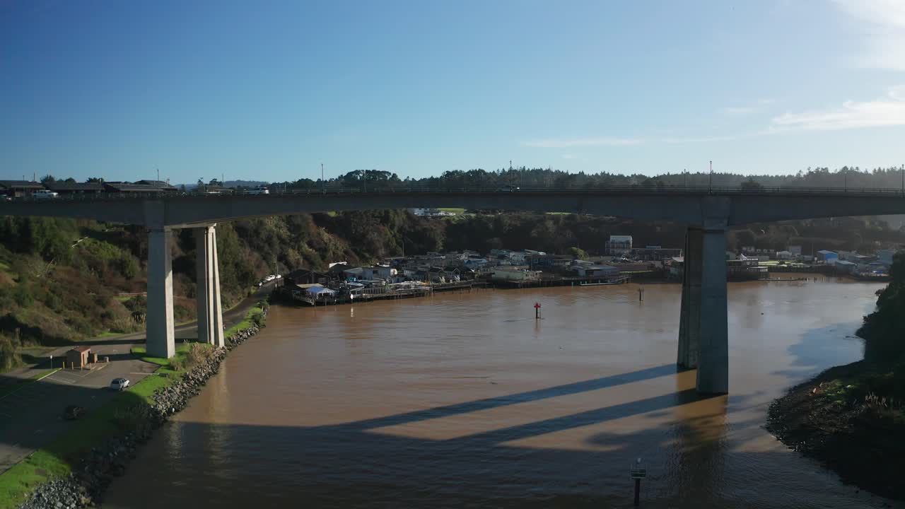 Aerial rising and panning shot of the Noyo River Bridge in Fort Bragg, California. 4K