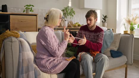 grandmother and grandson knitting together