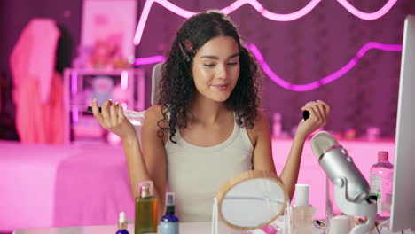 woman applying facial mist in beauty vlogging session