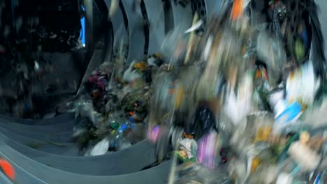 household trash is sorted in a machine, close up. waste sorting. conveyor for sorting waste. recycling garbage concept.