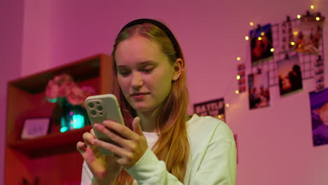 smiling young woman looking at her phone