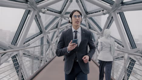 businessman walking on a modern bridge