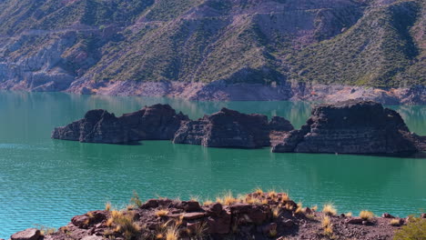 drone view of rocky shorelines on atuel canyon and reservoir in mendoza, argentina