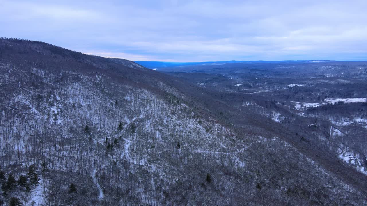 Aerial view of a snow covered mountain range in winter