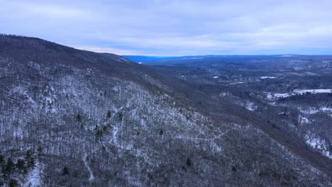 aerial view of a snow covered mountain range in winter