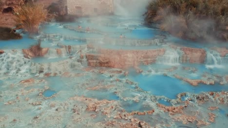 Touristen-An-Der-Cascate-Del-Mulino-In-Saturnia,-Manciano-In-Italien---Dampf-Steigt-Aus-Den-Thermalbädern-Auf