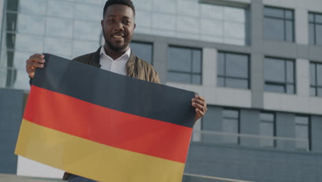 man holding german flag