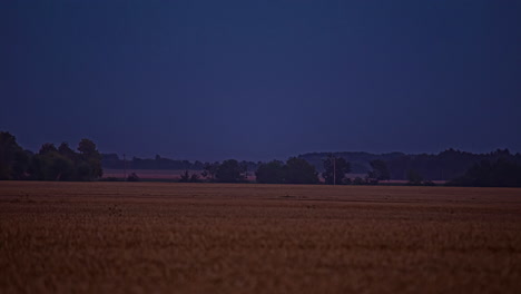 darkness comes a nightfall over farmland in rural europe - time lapse
