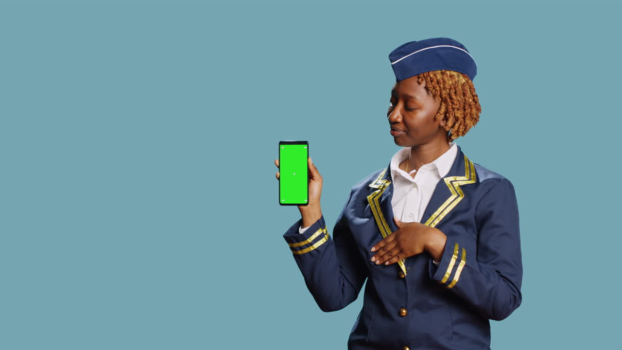 African american woman holding phone with greenscreen