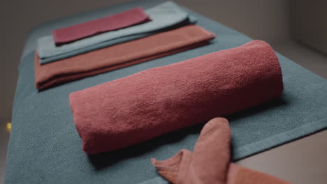 stacked towels on massage table