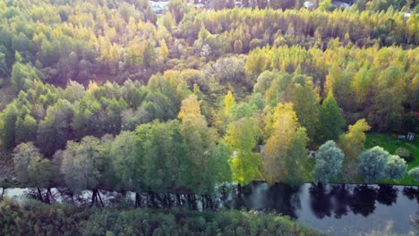 drone shot of a small private water canal with connection to lake tuusula in the rural town of järvenpää in finland, virgin pine forest