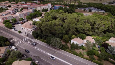 from an aerial perspective, the town reveals its charm as roads wind through the picturesque landscape adorned with majestic trees, creating a serene and inviting atmosphere for residents