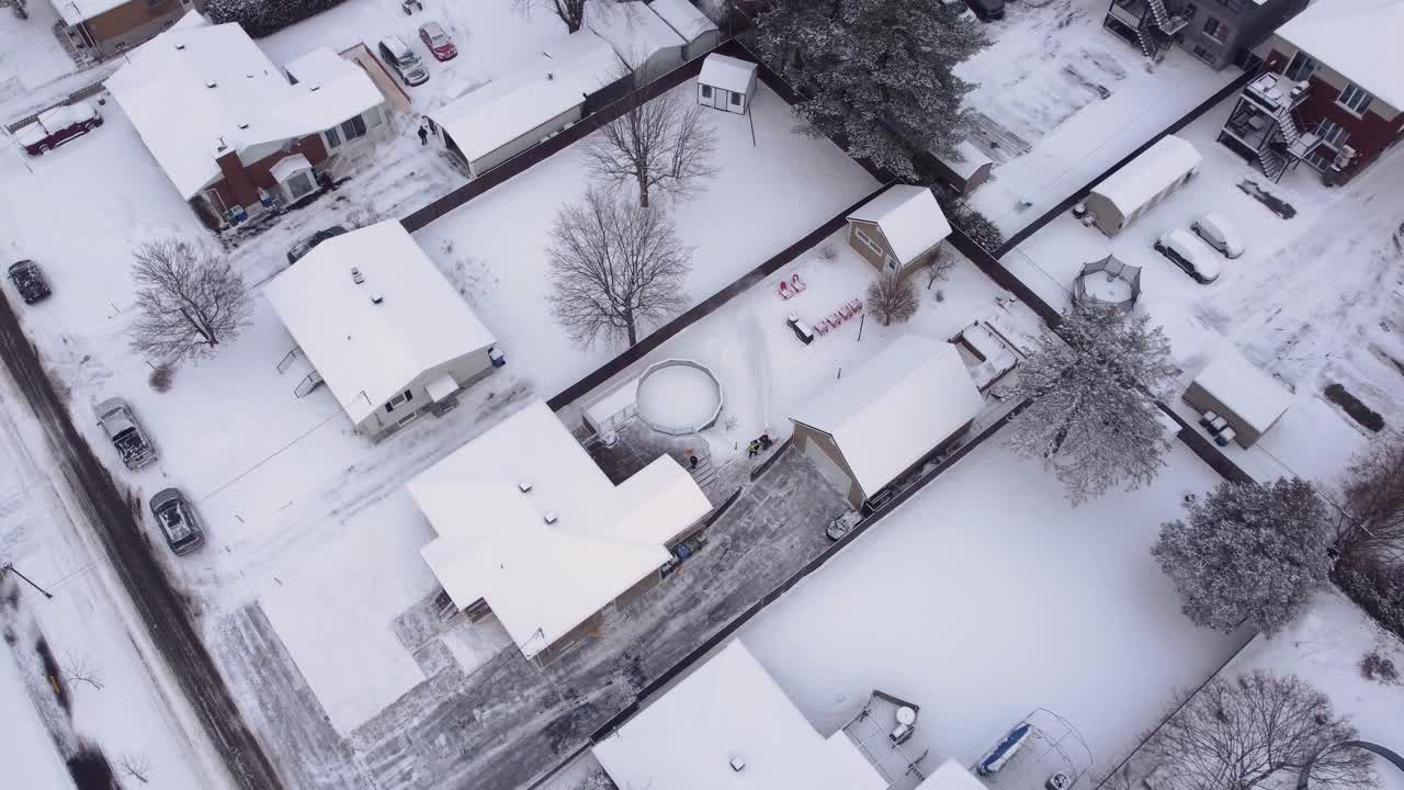 Drone footage of snow-covered roofs in city of St-Constant, Quebec, Canada