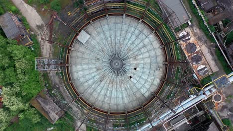Aerial top-down view of storage tank at abandoned steel factory