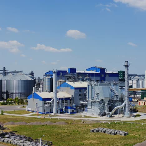 innovative granary in summer. modern territory for storing grains under blue sky. steel granaries for agribusiness.