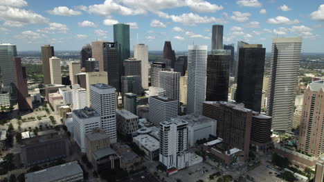 aerial view orbittng the downtown of houston, partly sunny day in texas, usa