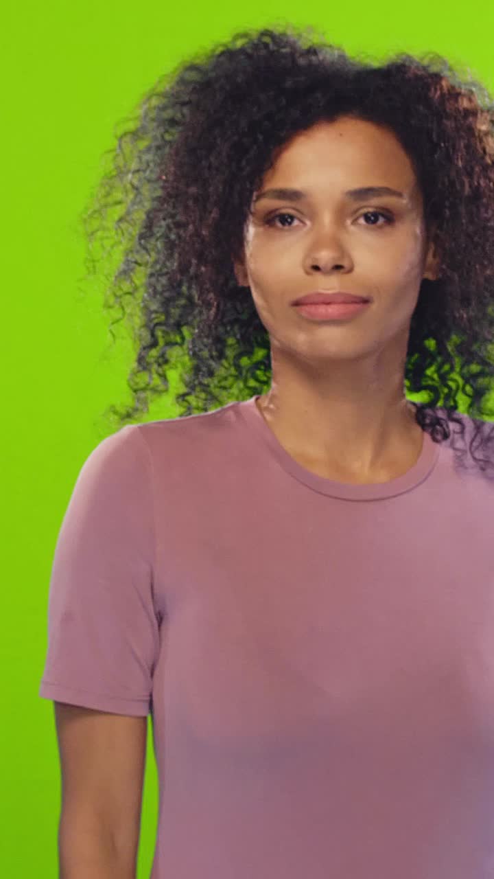 Young overjoyed african american woman covers mouth and makes winner gesture
