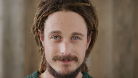 close up portrait of young man looking up smiling enjoying happy lifestyle cute caucasian male dreadlocks hairstyle blue eyes real people series