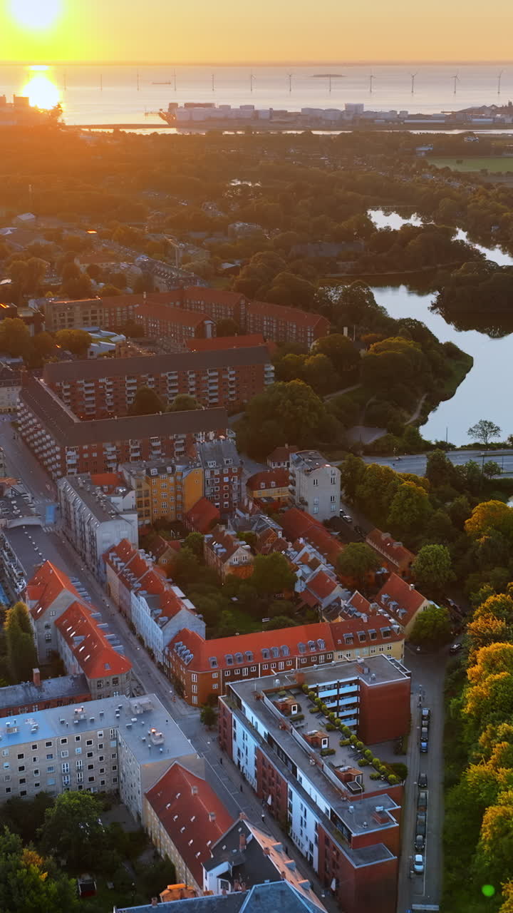 Aerial drone view of Amagerbro area in the northern part of the island Amager in Copenhagen, Denmark at sunset. Vertical