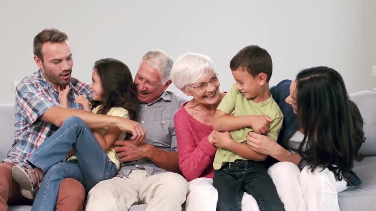 Cute multi generation family playing on the couch