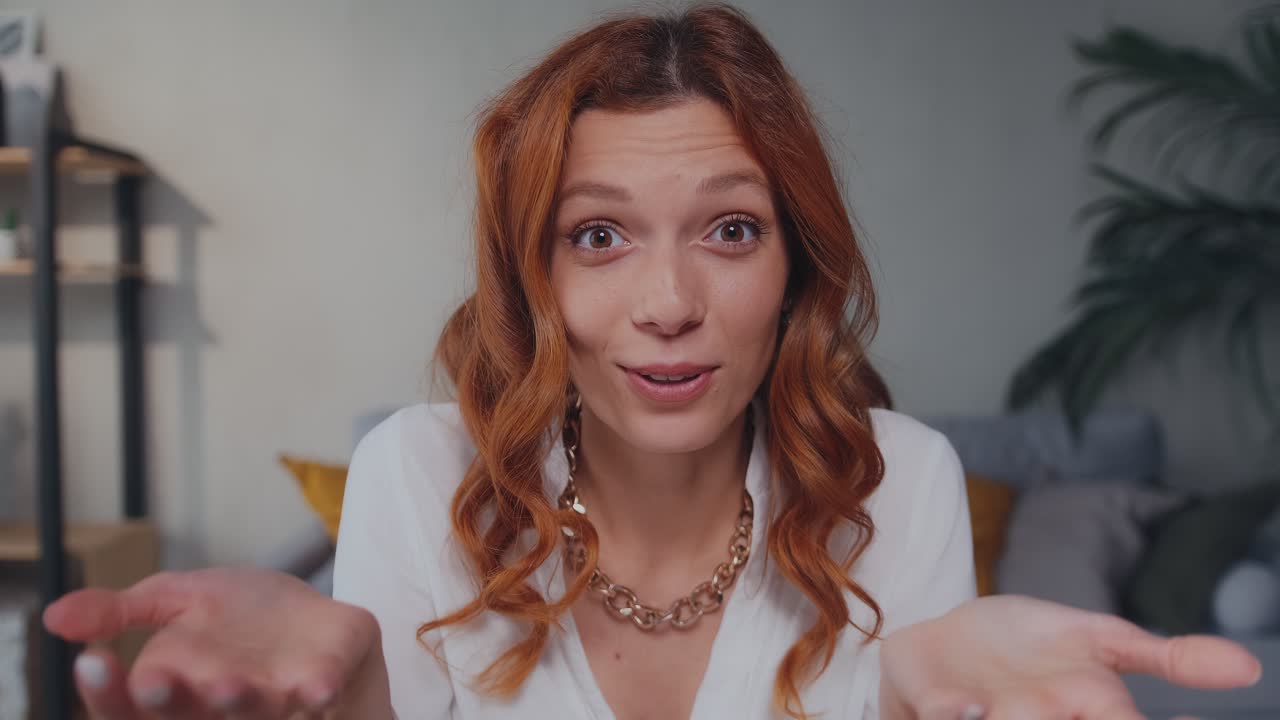 Attractive caucasian woman waves hand in greeting and carried away talking