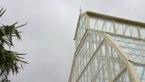 angular view of a greenhouse in the dublin botanic gardens with overcast skies