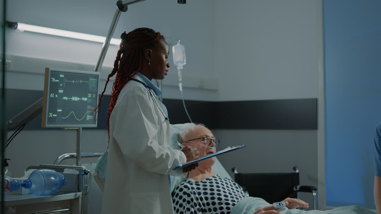 Nurse and african american doctor treat sick patient