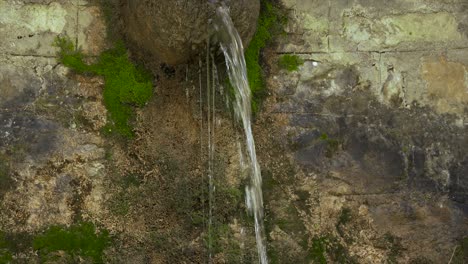 Drinking-fountain-with-crystal-cold-water-on-stone-wall-in-Mountain-village-of-Dardha,-Albania