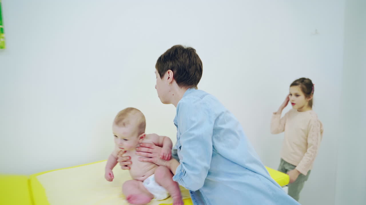 Baby checked by doctor. Woman with his baby visiting doctor in hospital