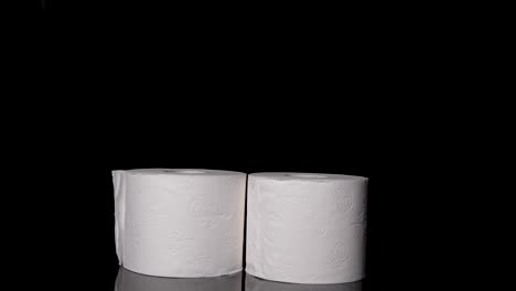 Toilet-Paper,-or-Bathroom-Tissue,-Rolls-in-front-of-a-Black-Background