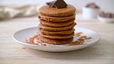 chocolate pancake stack with chocolate powder