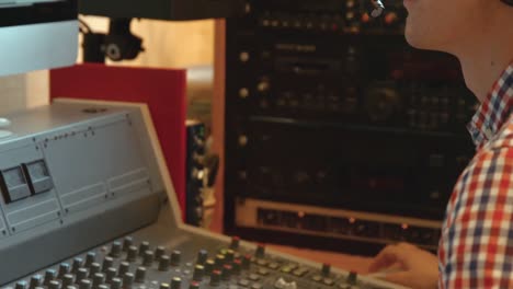 student mixing music in the studio