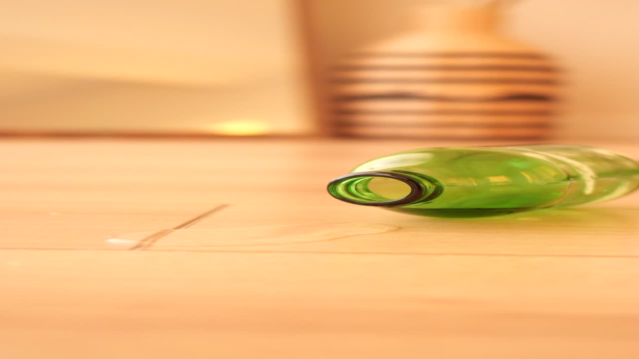 Empty Green Bottle on Wooden Floor