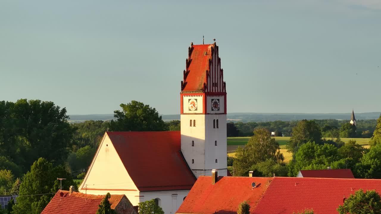 Picturesque Village Church with Red Roof and Clock Tower