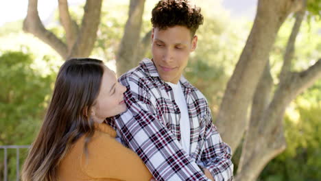 Happy-diverse-couple-standing-on-balcony-and-embracing-at-home,-in-slow-motion