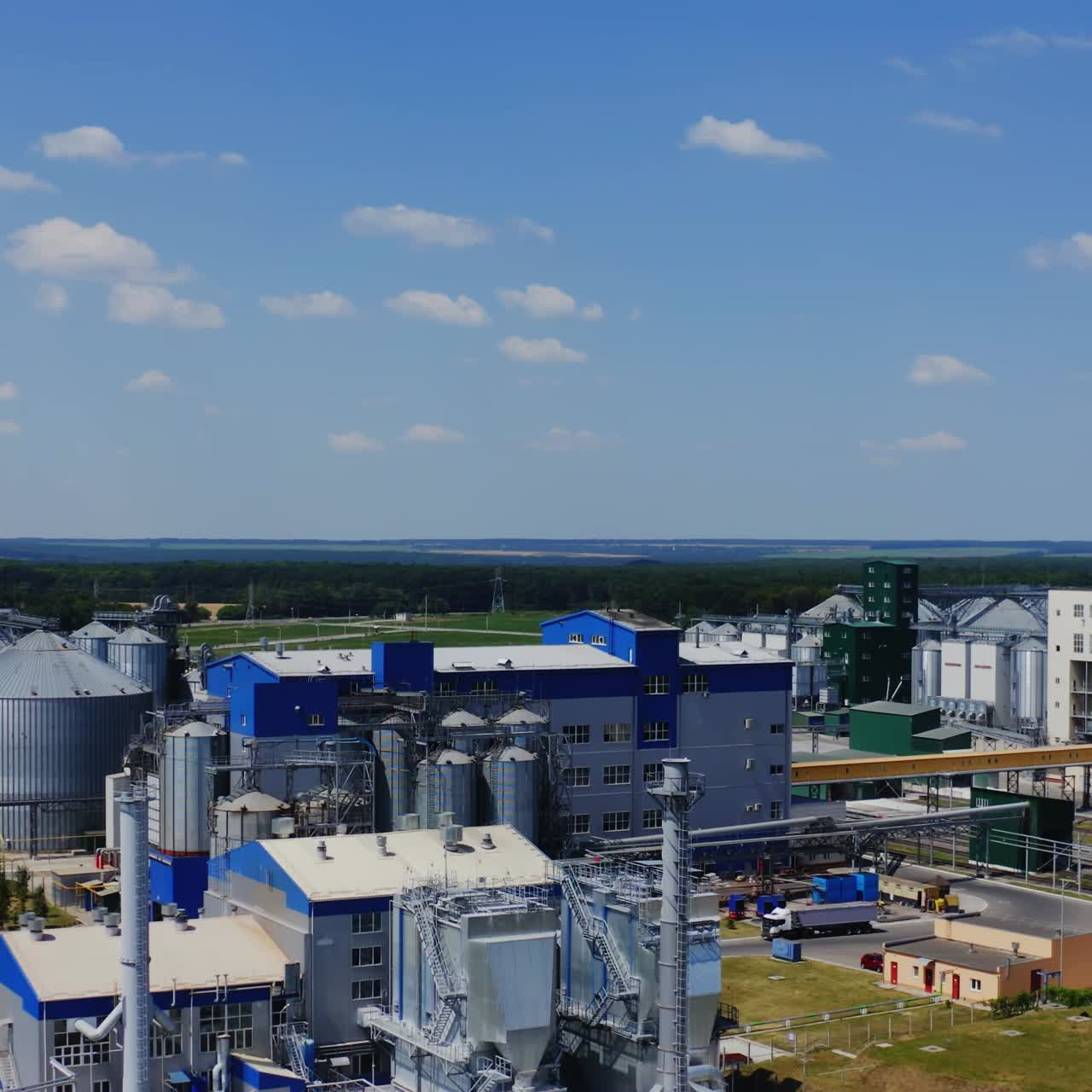Agribusiness concept.Agro manufacturing plant for processing drying cleaning and storage of agricultural products, flour, cereals and grain. Granary elevator. Aerial view concept video.