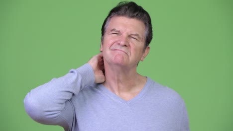 senior handsome man having neck pain