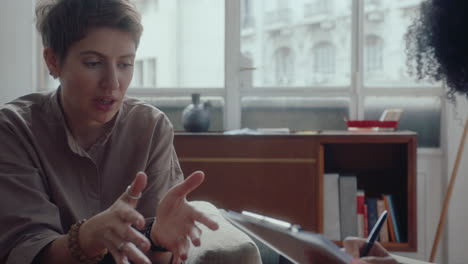 young woman consulting with female psychologist