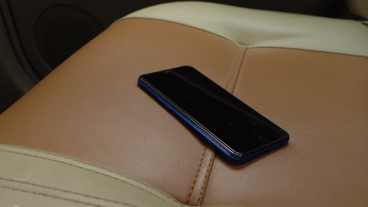 teléfono inteligente azul en un asiento de coche