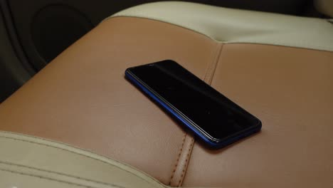 blue smartphone on a car seat