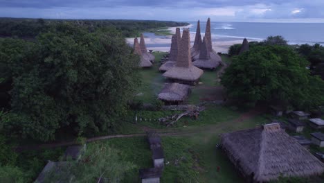 reveal shot of traditional village at sumba island cloudy day, aerial