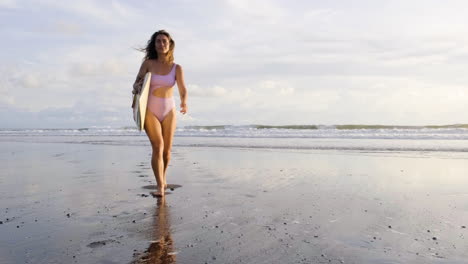 young woman with surfboard