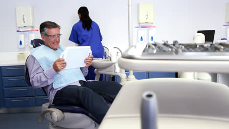 Patient-admiring-his-new-smile-in-the-mirror