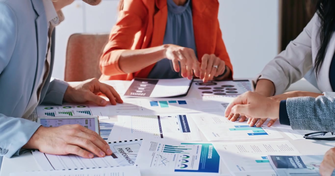 Business Team Analyzing Financial Charts and Data in Office Meeting