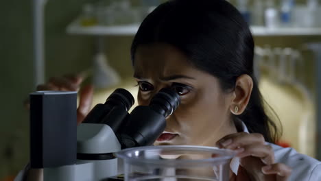 woman using a microscope in a laboratory