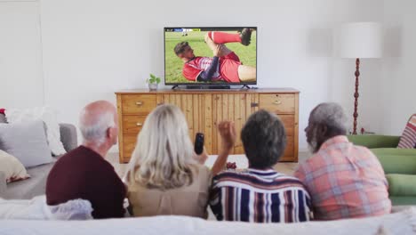 Video-of-diverse-group-of-senior-people-sitting-on-the-couch-and-watching-football-match